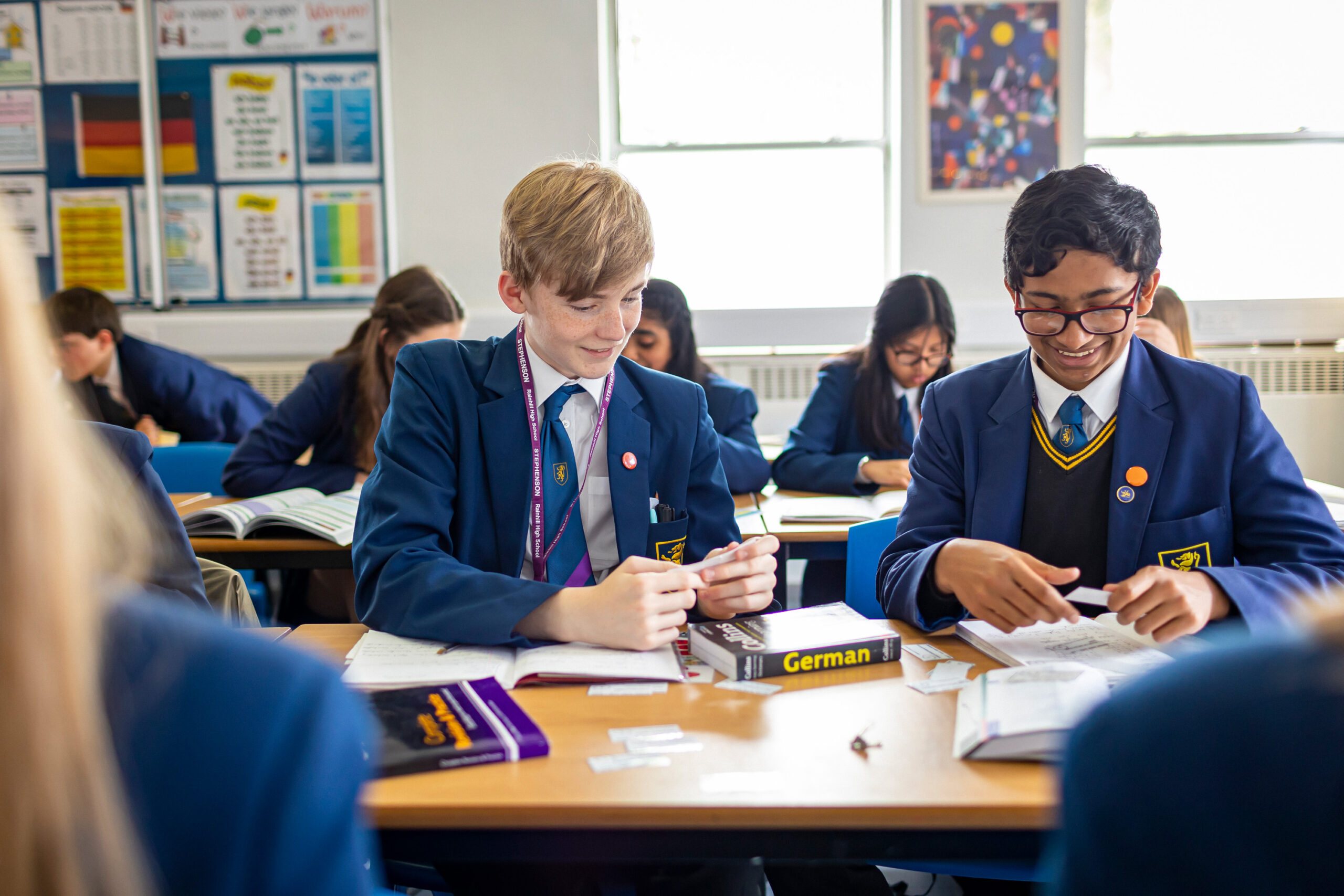 Student wearing headphones smiling during music class at Rainhill High School